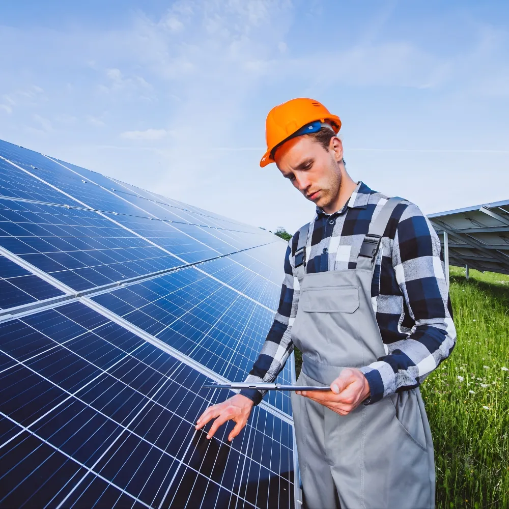 Solar array installed on farmland with wind turbines behind